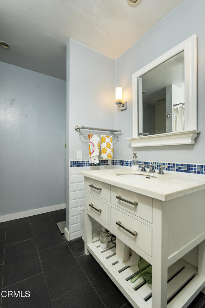 355 South Madison Avenue, Unit 212 Pasadena, CA 91101 - Photo 11 of 27 a bathroom with a sink and a mirror