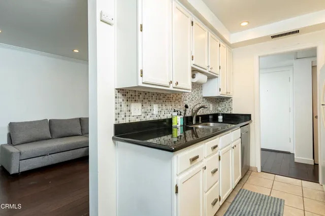 a kitchen with stainless steel appliances granite countertop a sink and a stove