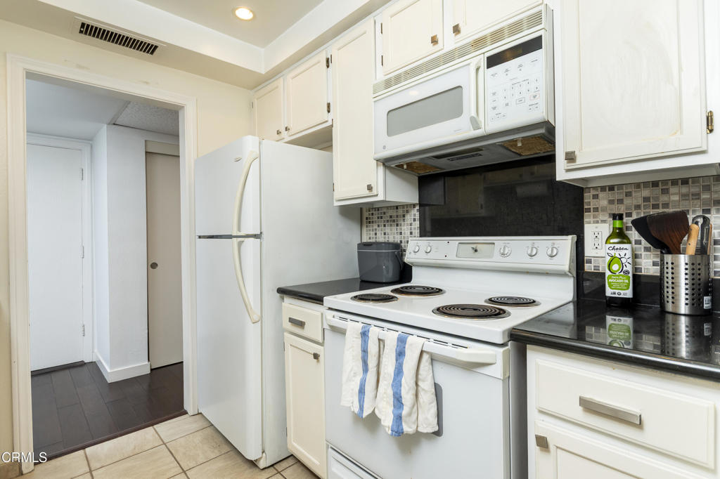 355 South Madison Avenue, Unit 212 Pasadena, CA 91101 - Photo 14 of 27 a kitchen with appliances a sink and cabinets