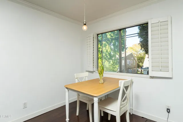a view of a dining room with furniture and a window