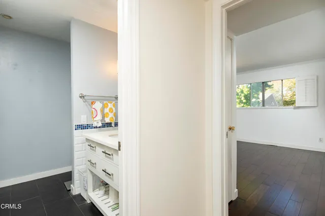 an empty room with window and wooden floor