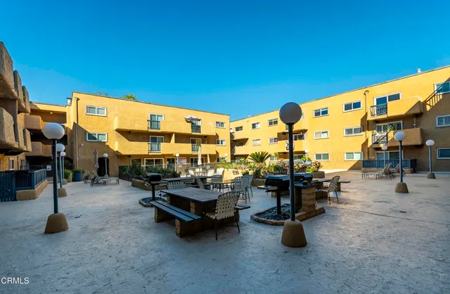 a view of a patio with dining table and chairs