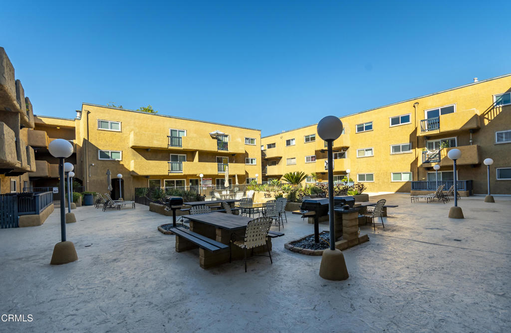 355 South Madison Avenue, Unit 212 Pasadena, CA 91101 - Photo 20 of 27 a view of a patio with dining table and chairs