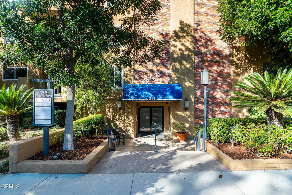 355 South Madison Avenue, Unit 212 Pasadena, CA 91101 - Photo 2 of 27 a view of a house with potted plants and a large tree