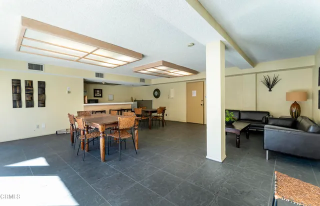 a view of a livingroom with furniture and a window