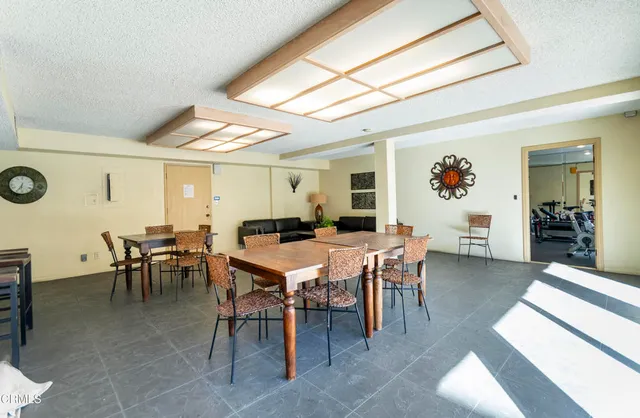 a view of a dining room with furniture and a potted plant