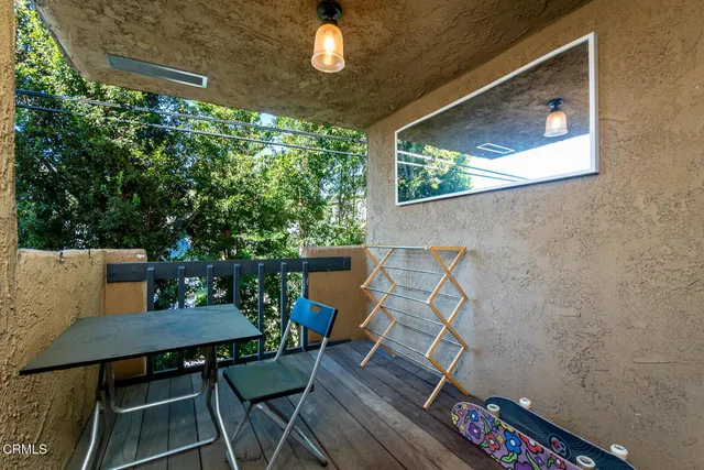 a view of a chairs and table in the balcony