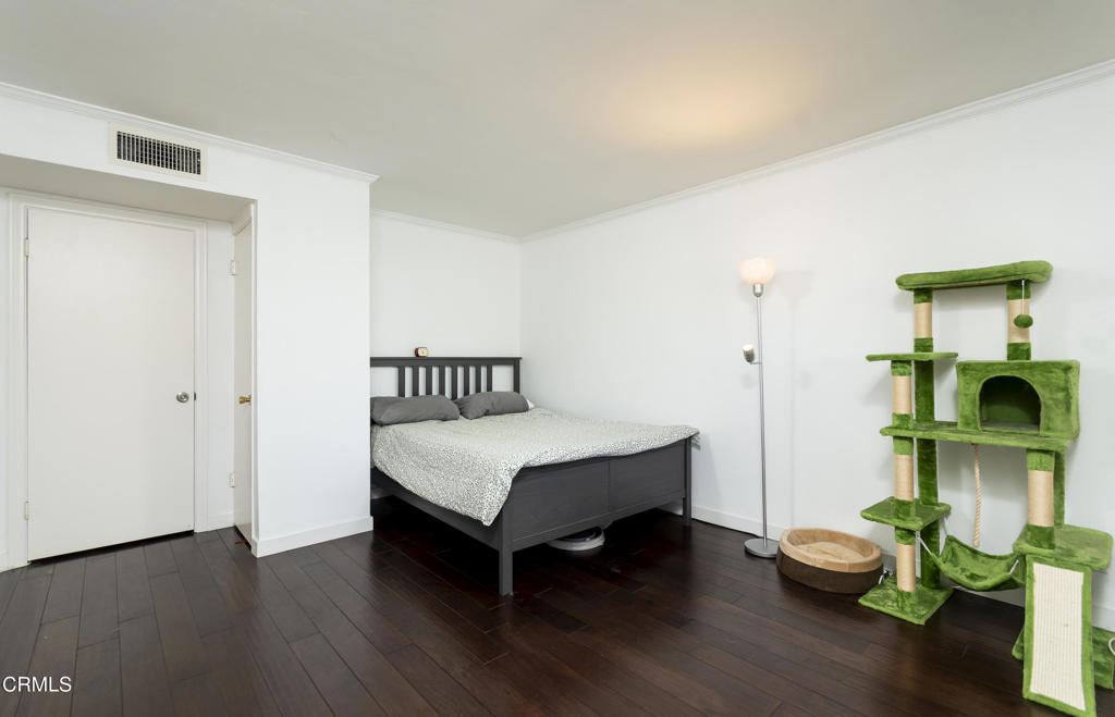 355 South Madison Avenue, Unit 212 Pasadena, CA 91101 - Photo 9 of 27 a bedroom with a bed and a chandelier