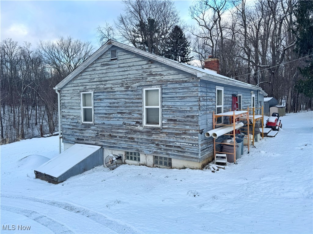 72117 Barton Road Bridgeport, OH 43912 - Photo 21 of 42 View of snow covered exterior with a chimney