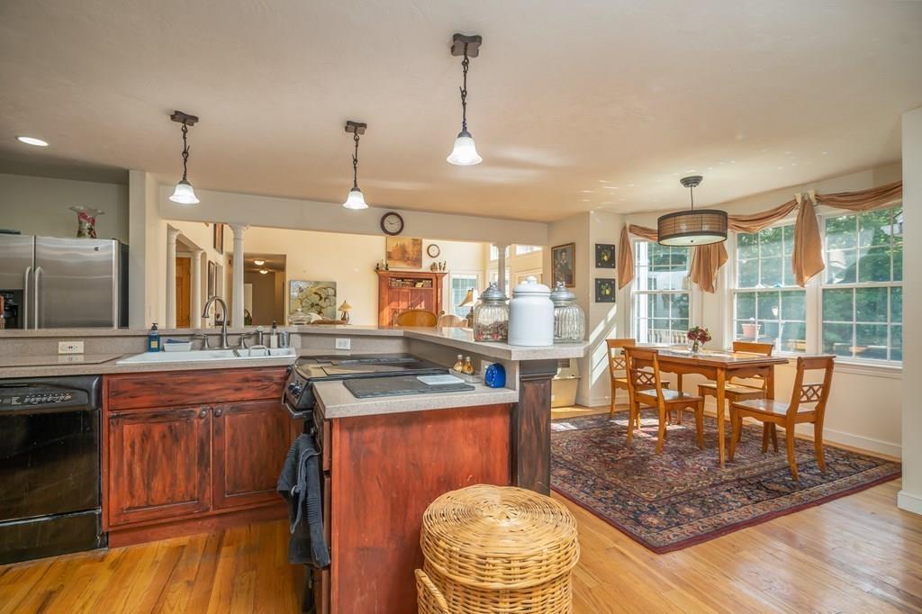 70 Allen Hill Road Holland, MA 01521 - Photo 8 of 36 a kitchen with a stove a sink a counter space and dining table