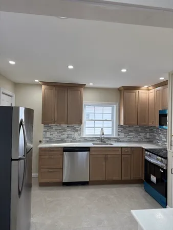 a kitchen with a sink stainless steel appliances and counter space