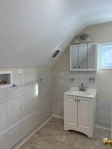 a bathroom with a sink a toilet and vanity