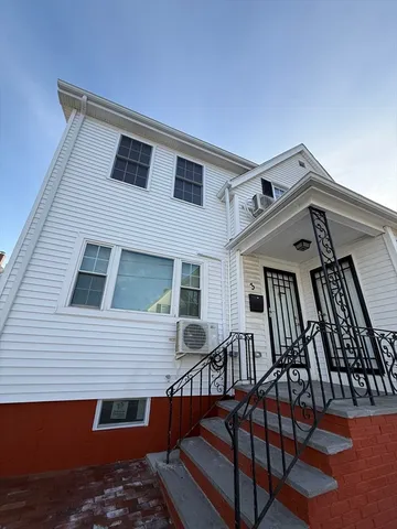a view of a house with a wooden deck