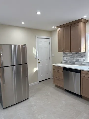 a view of kitchen with a refrigerator a sink and dishwasher