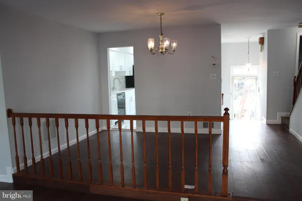 a view of a hallway view with wooden floor and staircase