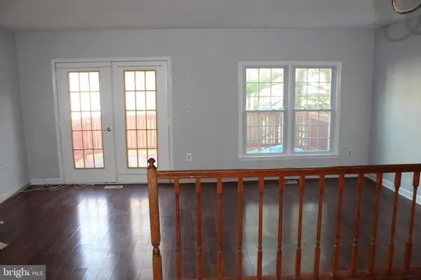 a view of wooden floor and a window in a room