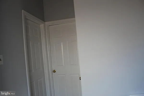 a view of a hallway with wooden floor and stairs