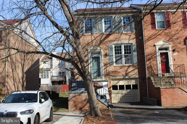 a front view of residential houses with parking space