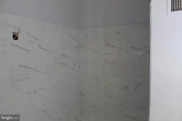 a white toilet sitting next to a small bathroom