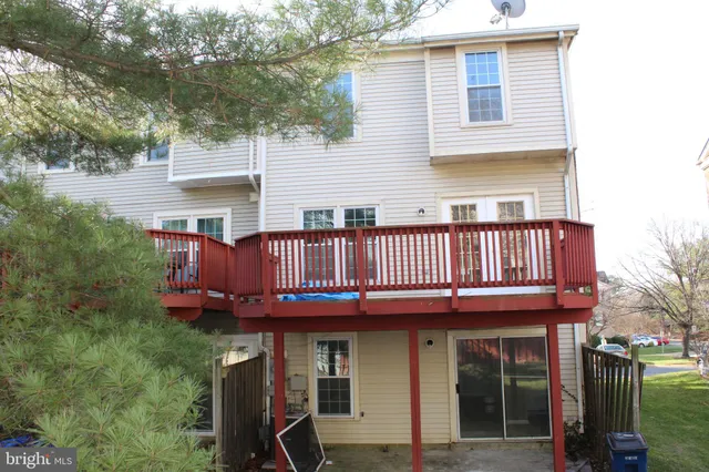 a view of a house with a deck and furniture