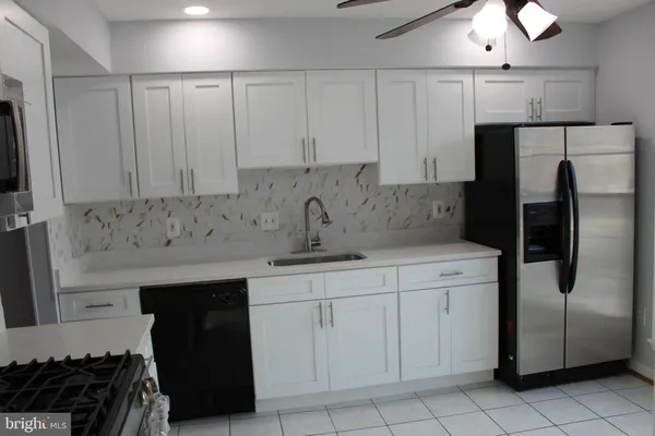 a kitchen with a sink and refrigerator