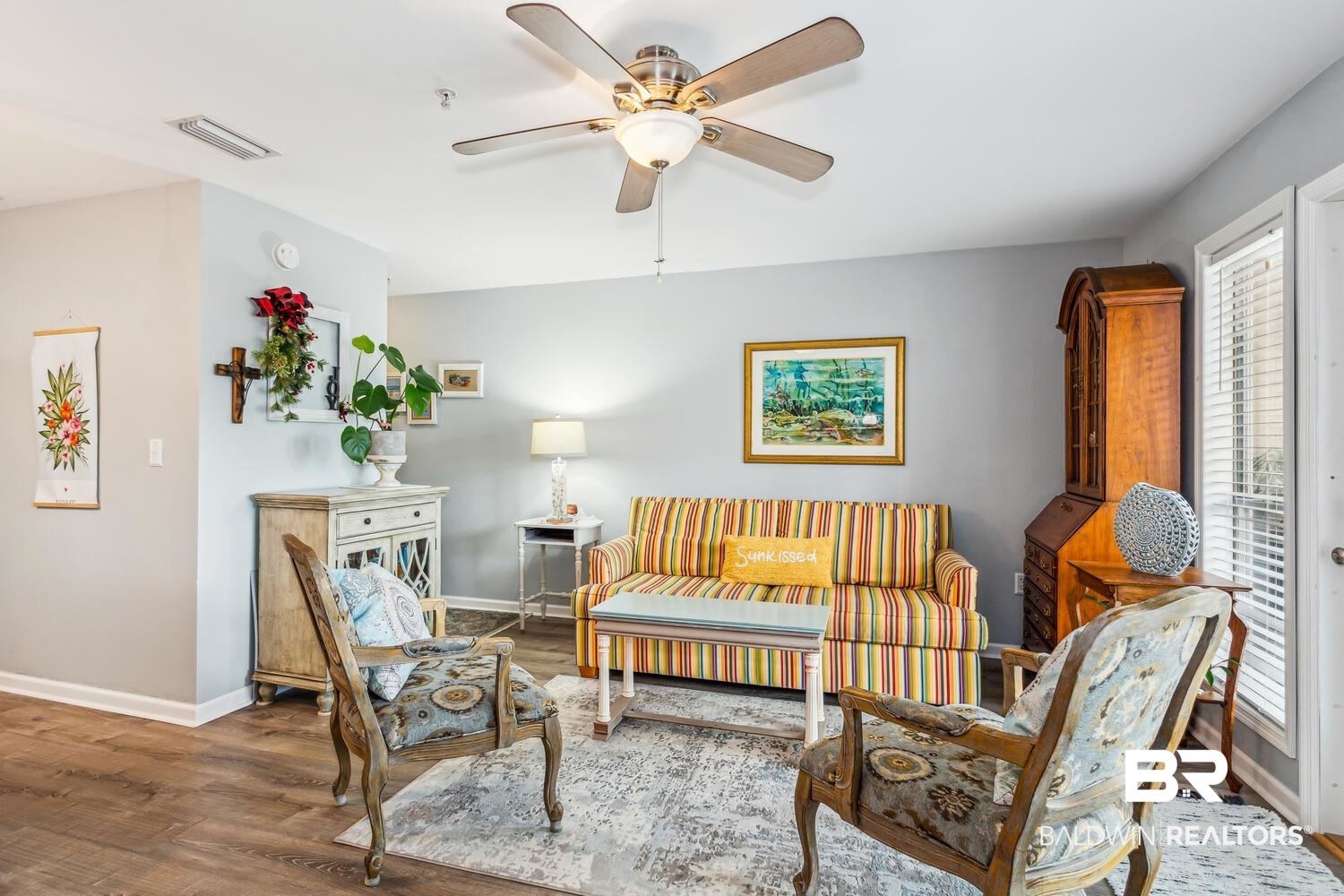 13551 Johnson Beach Road, Unit 112E Pensacola, FL 32507 - Photo 8 of 42 Living area featuring ceiling fan, wood-type flooring, and plenty of natural light