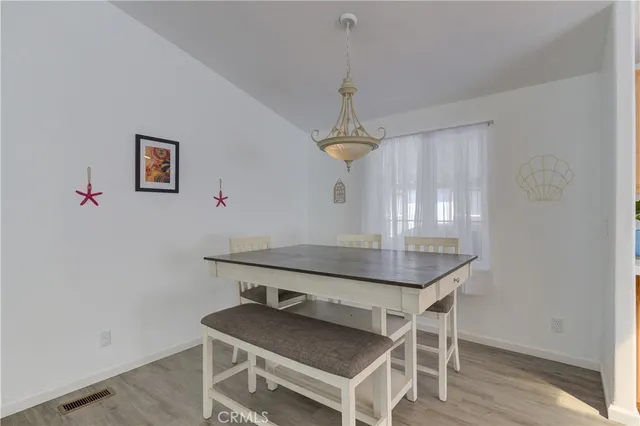 a kitchen with granite countertop stainless steel appliances a sink cabinets and a window