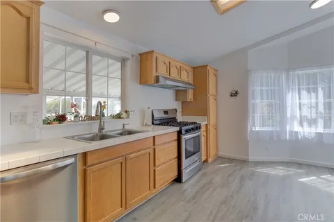 a kitchen with granite countertop a refrigerator and a sink