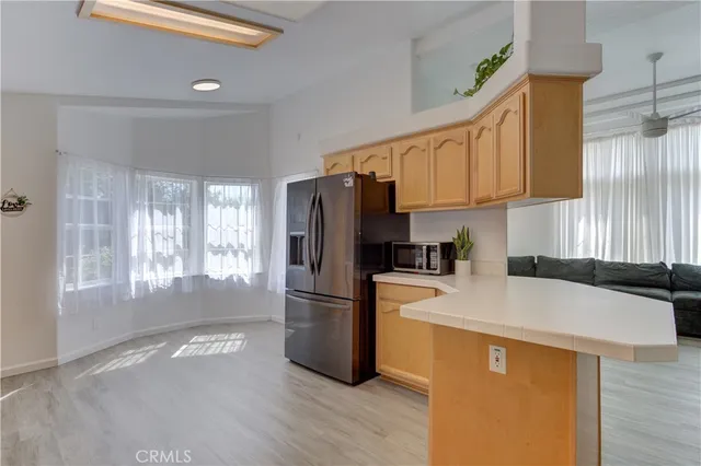 a kitchen with stainless steel appliances granite countertop a refrigerator and a stove top oven