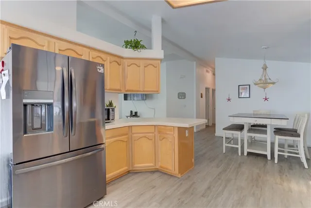 a kitchen with granite countertop a stove top oven a sink dishwasher and white cabinets with wooden floor