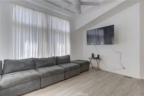 a living room with furniture a dining table and a wooden floor