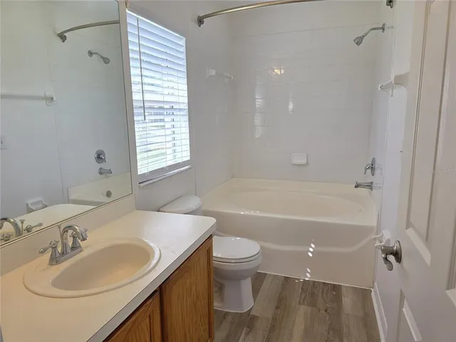 a bathroom with a sink toilet tub and shower