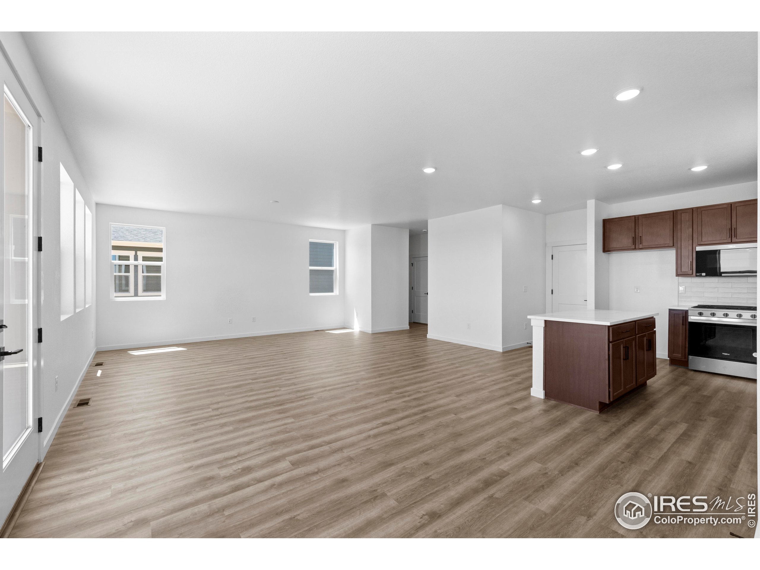 737 Muturu Road Johnstown, CO 80534 - Photo 11 of 26 a view of kitchen with furniture and wooden floor