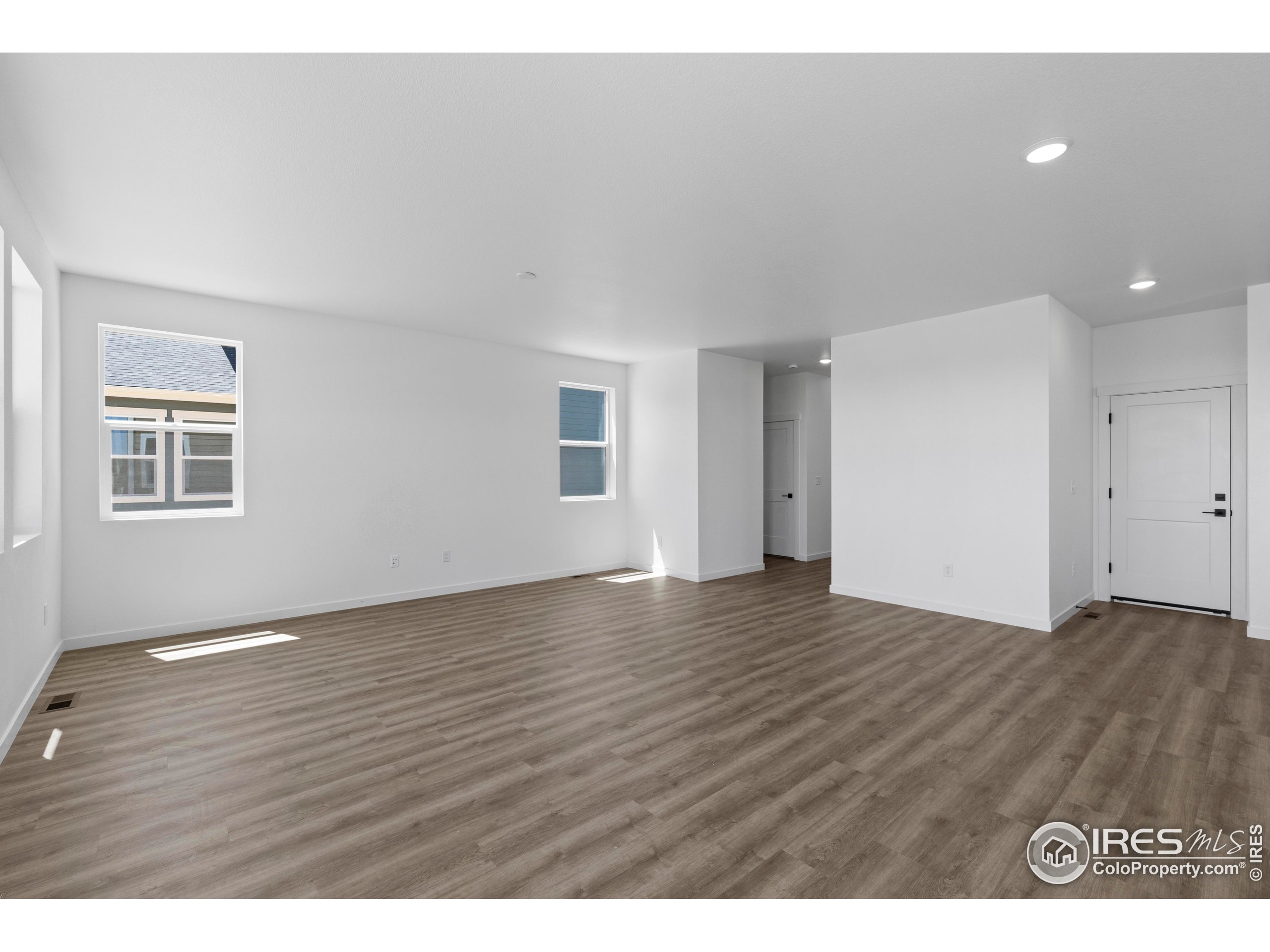 737 Muturu Road Johnstown, CO 80534 - Photo 12 of 26 a view of an empty room with wooden floor and a window