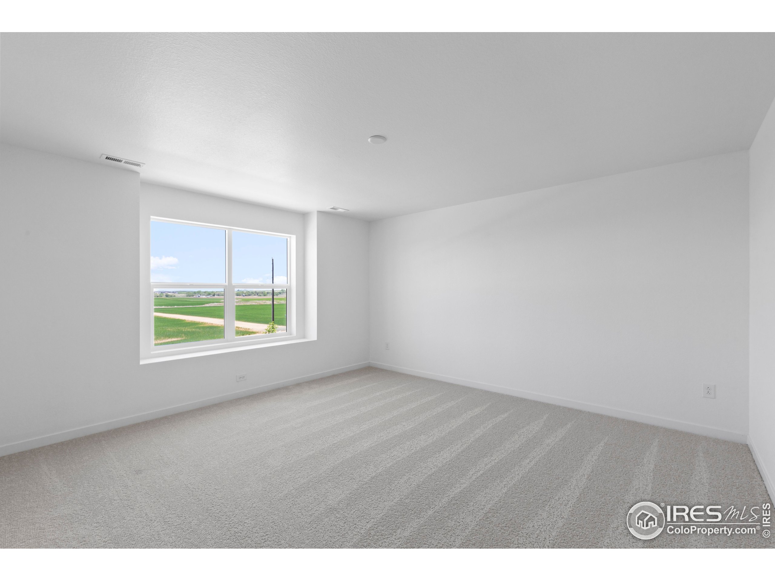 737 Muturu Road Johnstown, CO 80534 - Photo 19 of 26 a view of an empty room with a window
