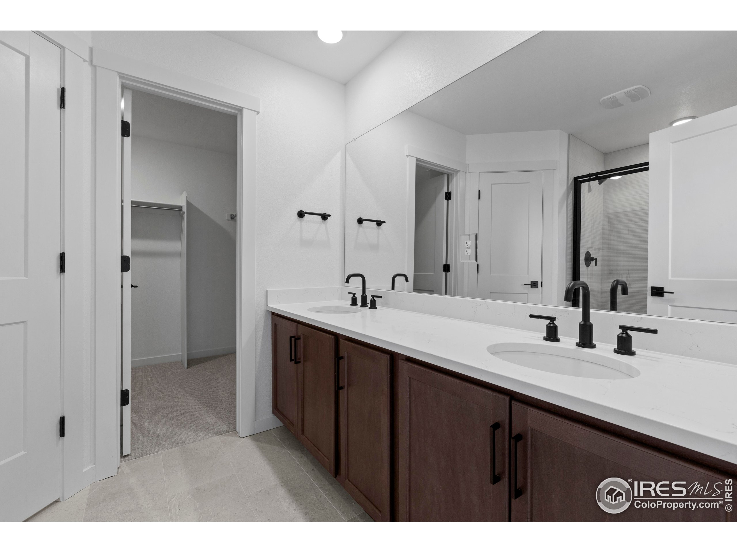 737 Muturu Road Johnstown, CO 80534 - Photo 21 of 26 a bathroom with a sink and a mirror