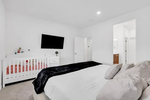 a bedroom with a bed and a flat screen tv