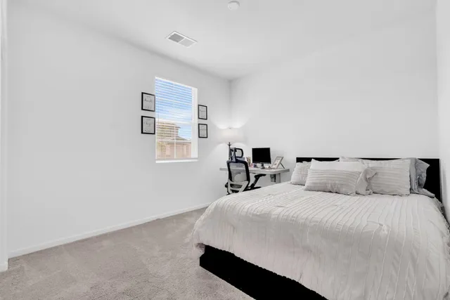 a bedroom with a bed and cabinets