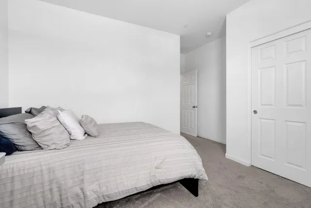 a bedroom with a bed and pillows