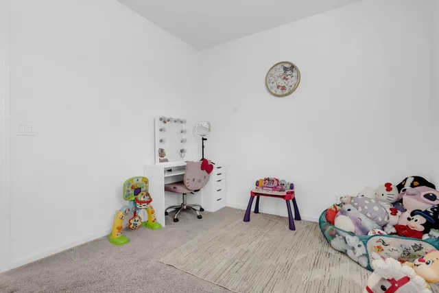 a view of play room with toys and wooden floor