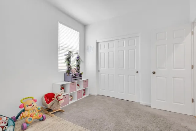 an empty room with toys and dresser