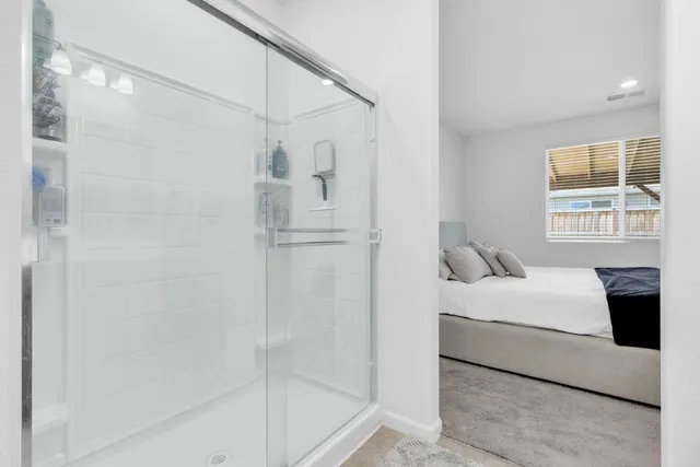 a bedroom with a bed and a window