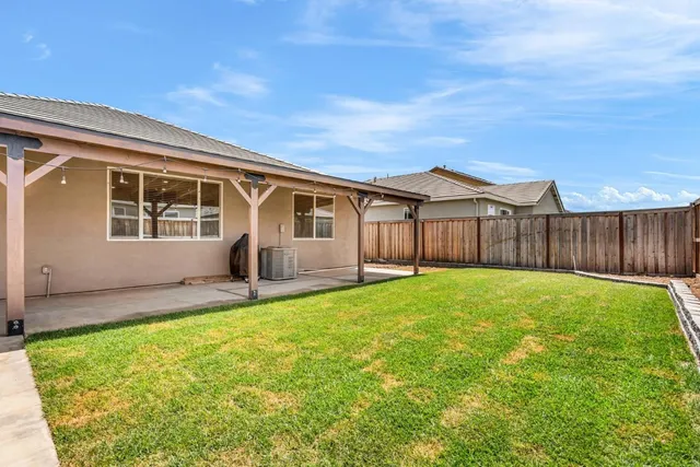 a view of a house with a backyard and a garden