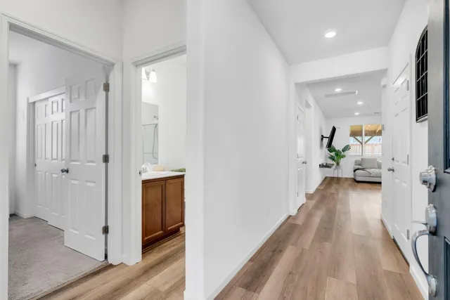 a view of a hallway view with wooden floor and staircase