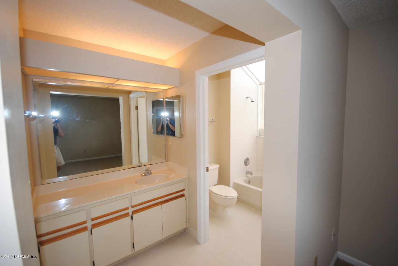 605 Tournament Road Ponte Vedra Beach, FL 32082 - Photo 5 of 10 a bathroom with a double vanity sink toilet and shower