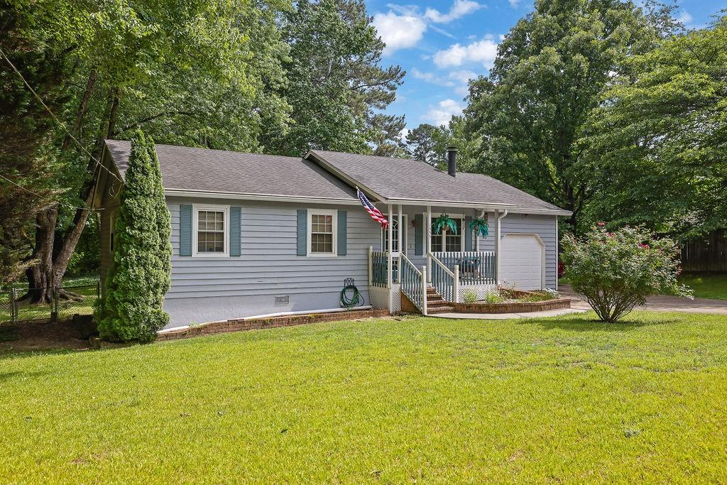 1555 Rock Springs Road Buford, GA 30519 - Photo 3 of 27 a front view of a house with a garden and trees
