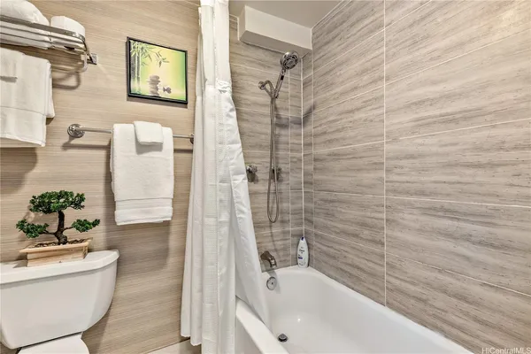 a bathroom with a bathtub and shower