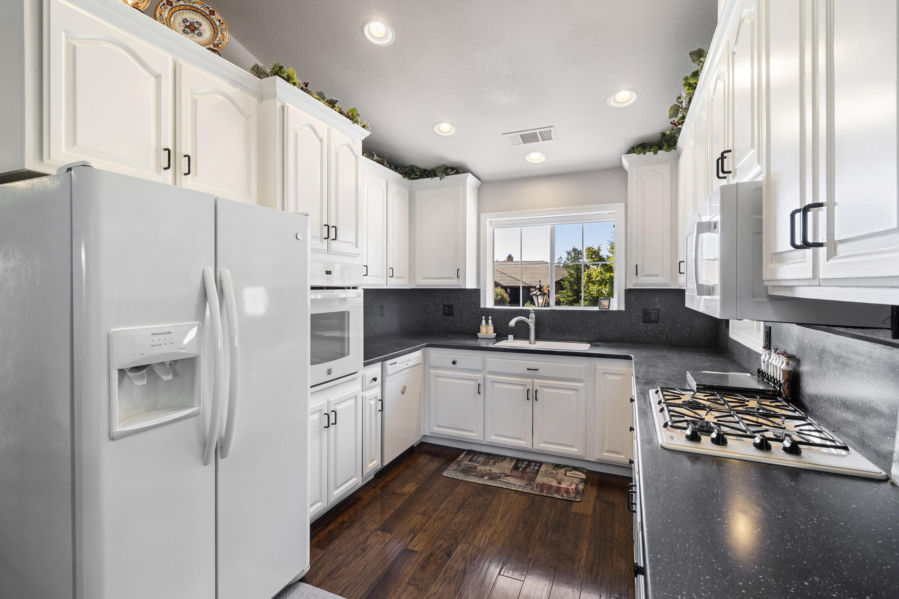 3884 Andes Drive Redding, CA 96001 - Photo 14 of 56 a kitchen with white cabinets and white appliances