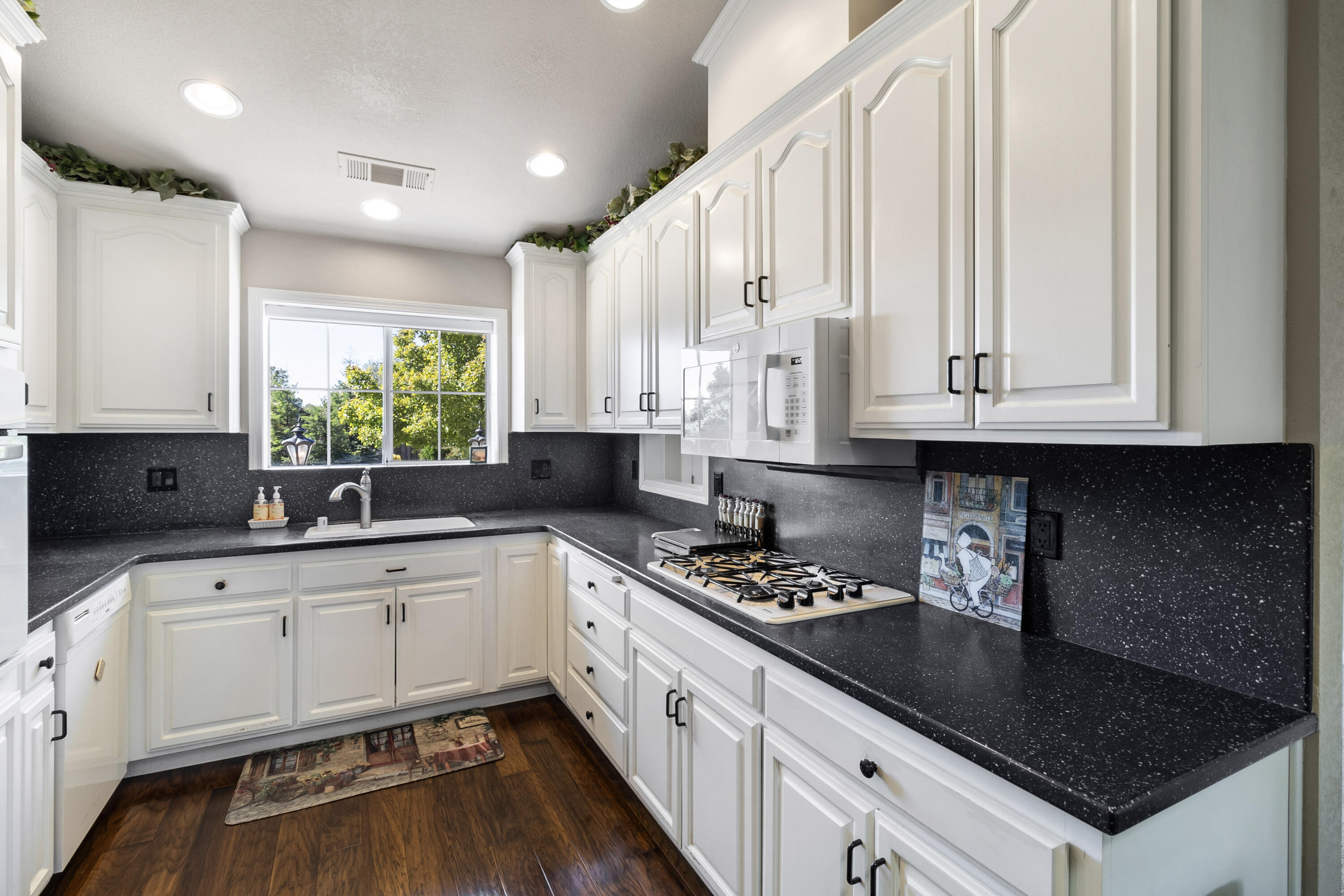 3884 Andes Drive Redding, CA 96001 - Photo 15 of 56 a kitchen with stainless steel appliances granite countertop a sink stove and cabinets