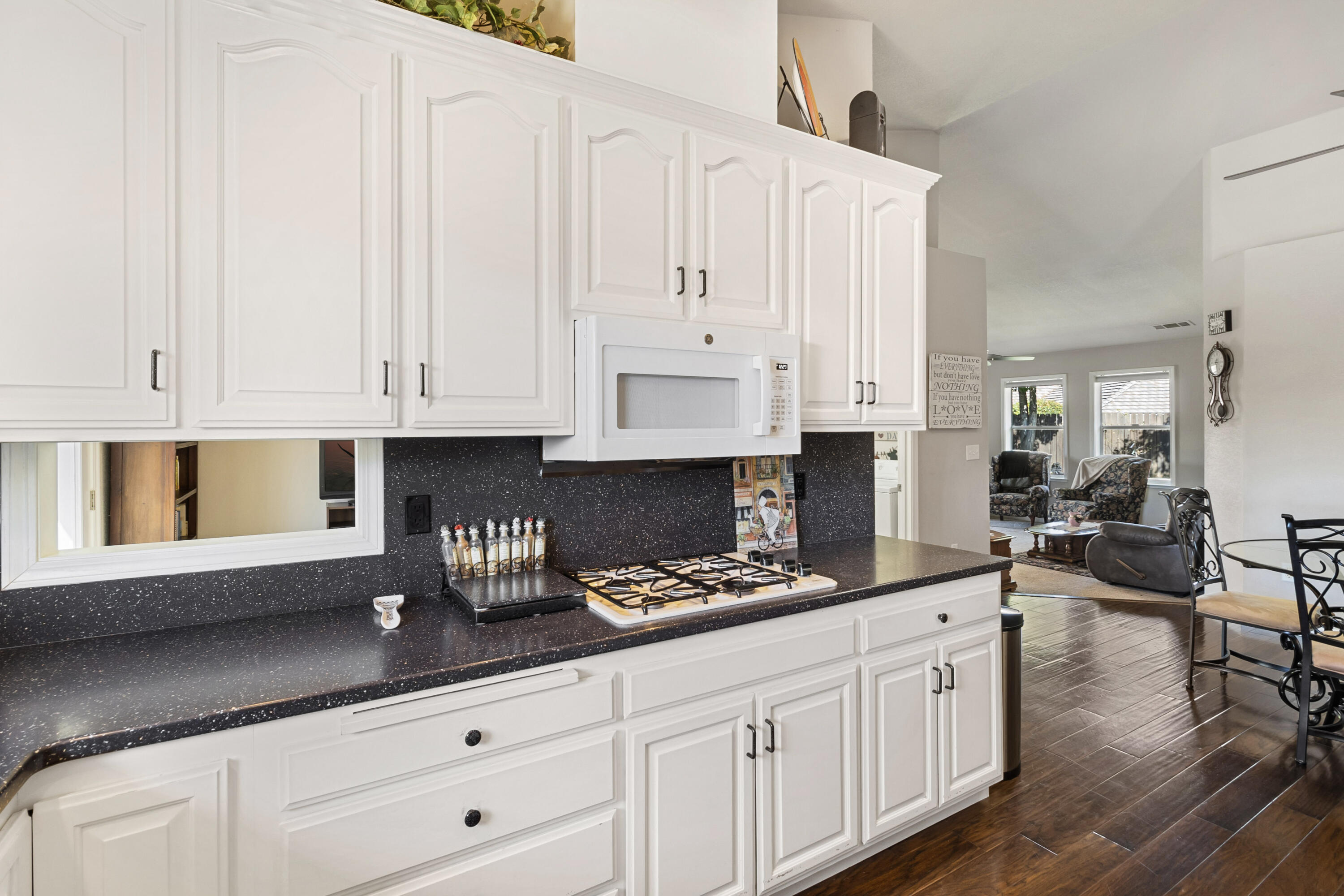 3884 Andes Drive Redding, CA 96001 - Photo 16 of 56 a kitchen with stainless steel appliances granite countertop a stove a sink and white cabinets